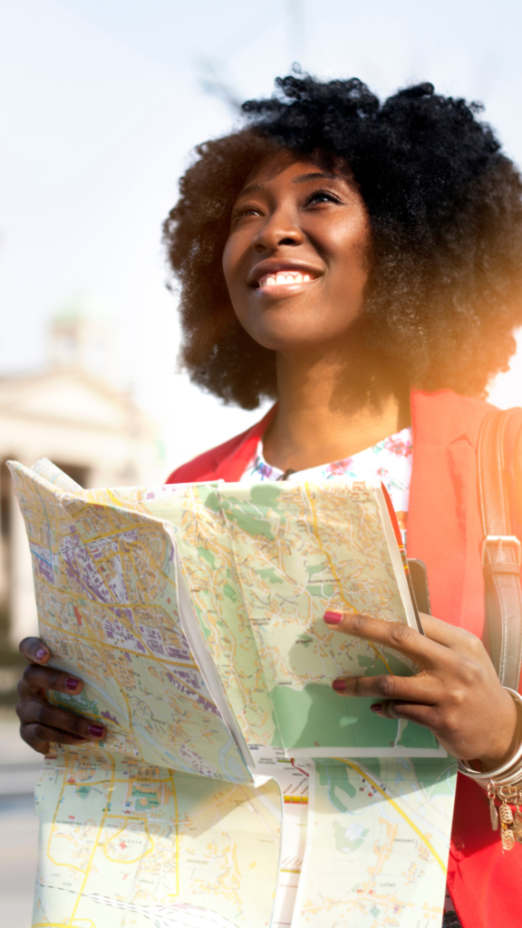 A woman holding a travel map, ready to channel her inner growth, explore the world, and discover new experiences