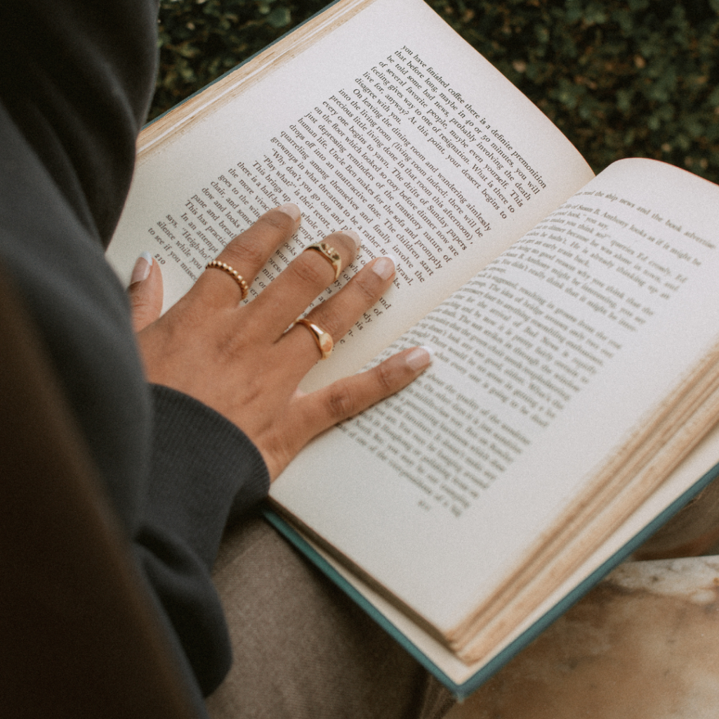 A person reading an inspiring book, symbolizing personal growth and the transformative power of literature.