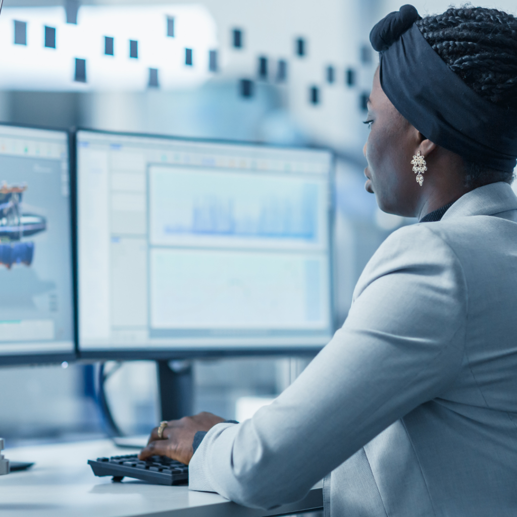 A woman focused on her work at a computer, symbolizing her role and achievements in the technology industry