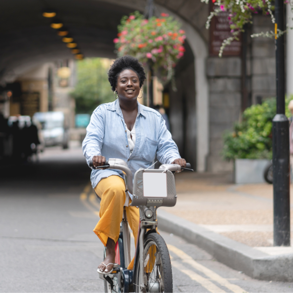 A woman riding a bike, symbolizing adventure and the thrill of traveling while exploring new destinations