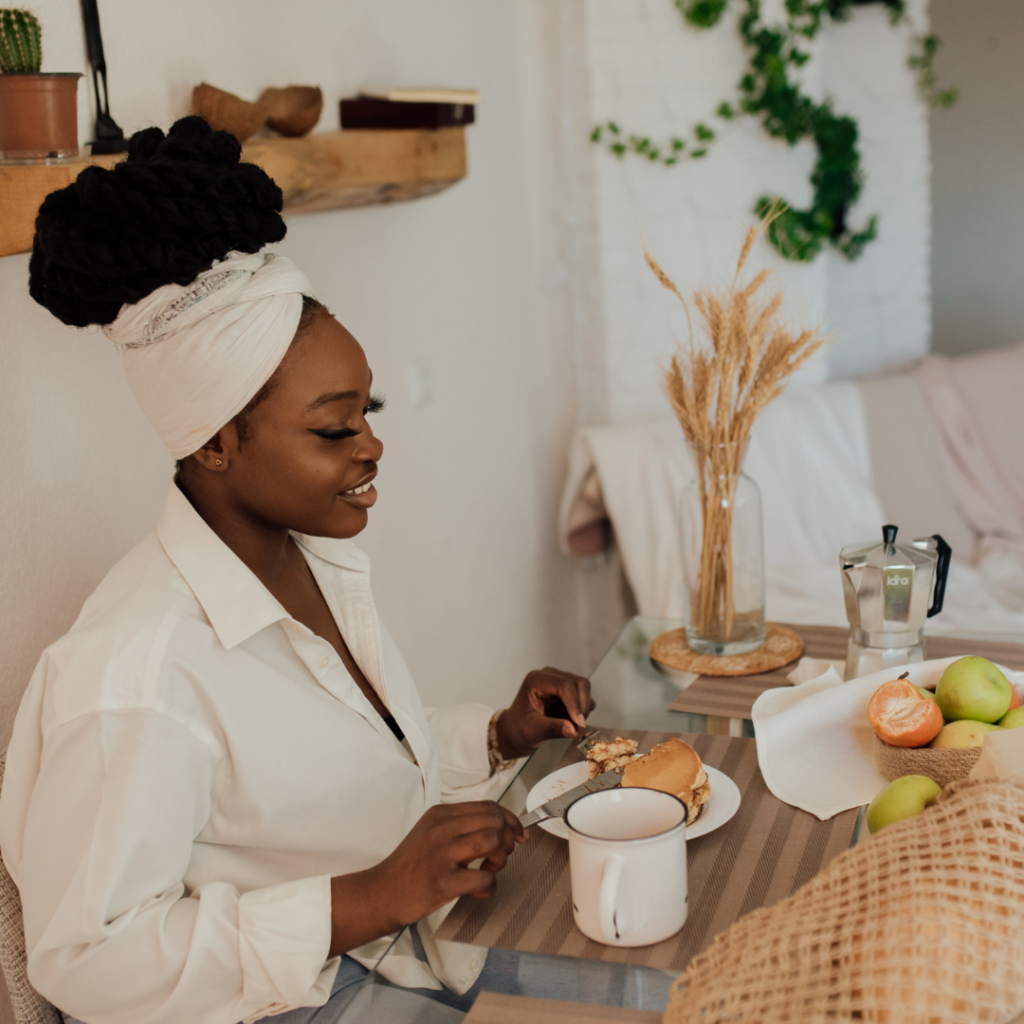 A woman eating breakfast by herself at a cafe during vacation, reflecting tranquility and the pleasure of solo travel.